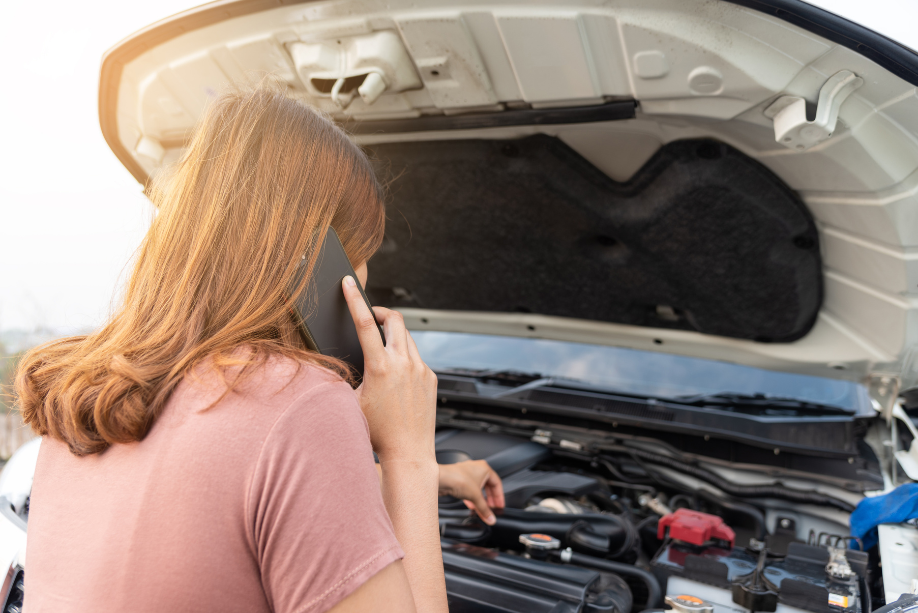 girl calling for help while her car broke down
